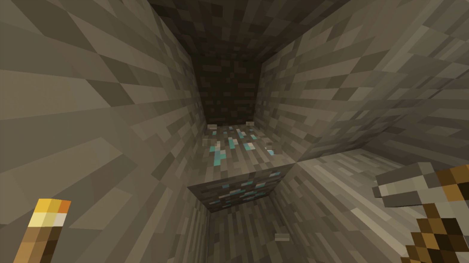 Minecraft game image, diamond block infront of player in 1st person with a torch in left hand and stone pick in the right
